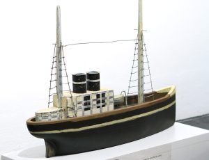 Peter Mates 'Number 93' (Oct. 1998). 60 or more remain in the artist’s studio.  He would part with the entire fleet for a very modest sum. A boat based on those in paintings by Alfred Wallis.  Peter has carved over 100 of these out of wood from decommissioned Newlyn fishing boats i\n the spirit of Alfred Wallis, who collected old iron. Wood & Paint, 32 x 43 x 9cm, £450